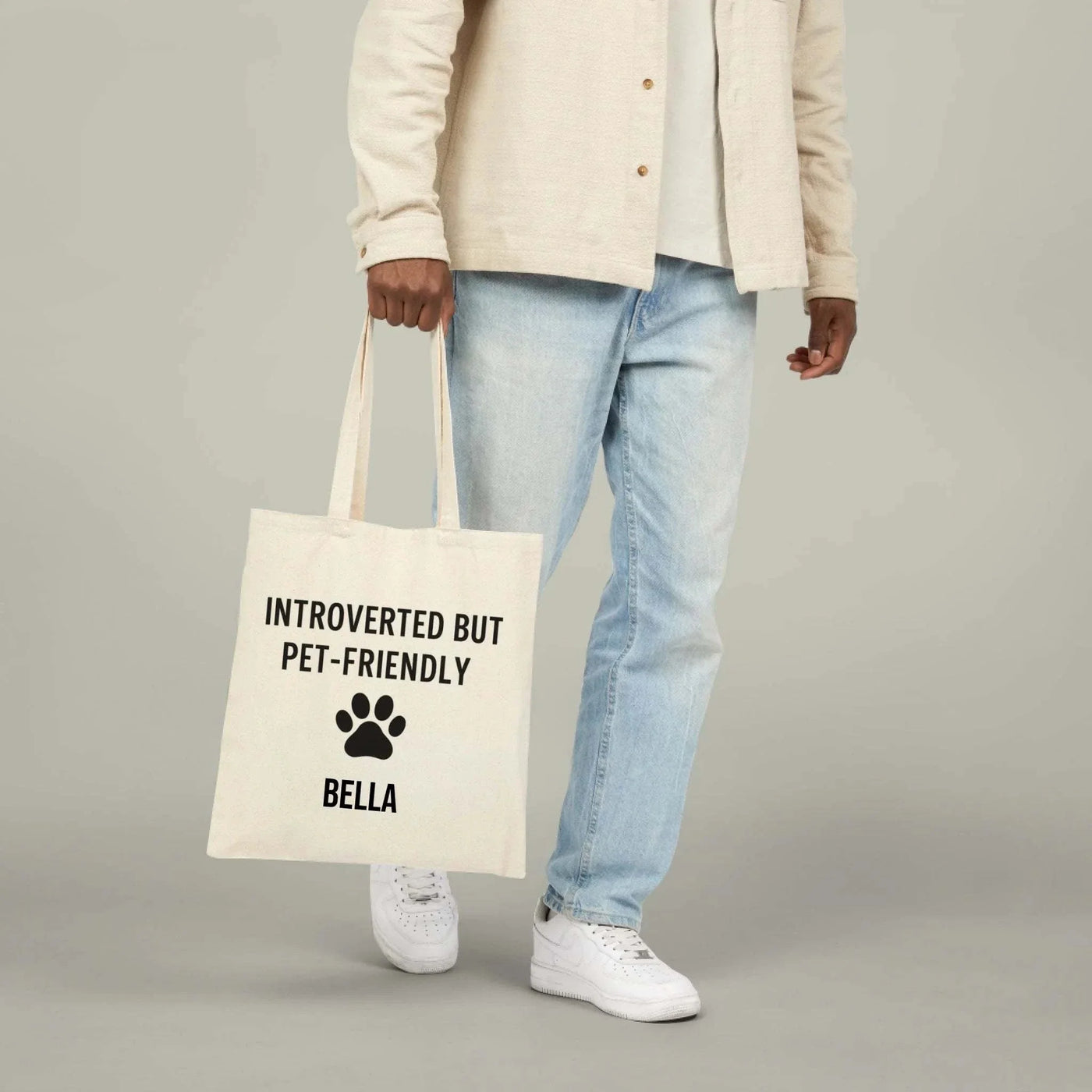 Cotton canvas tote bag with "Introverted but pet-friendly" text and paw print design, natural color, 15" x 16" size with 20" handles.